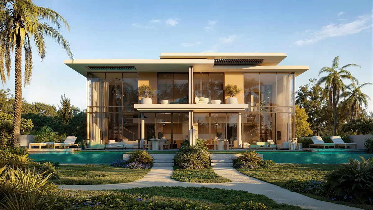 An attached villa seen from its garden and pool
