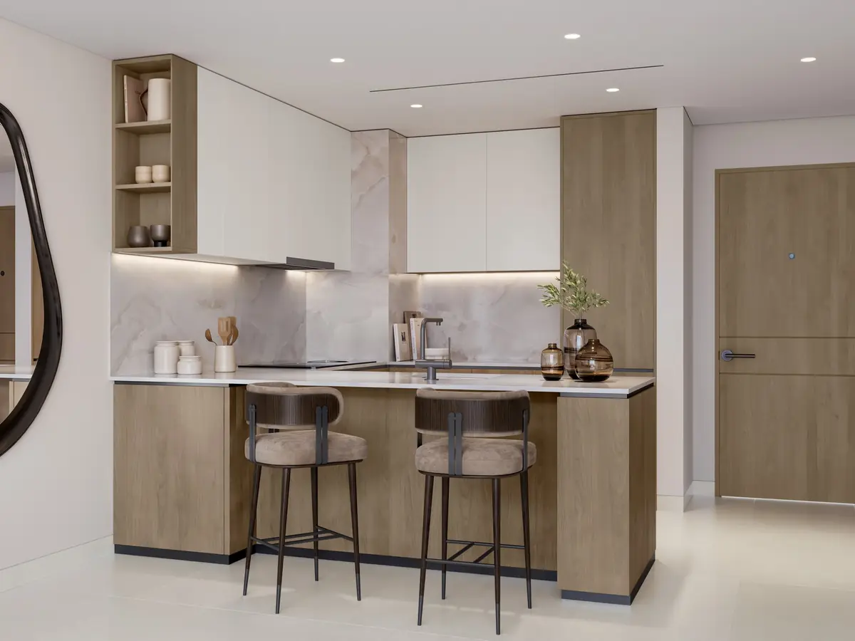 An apartment kitchen with stone countertops and timber joinery
