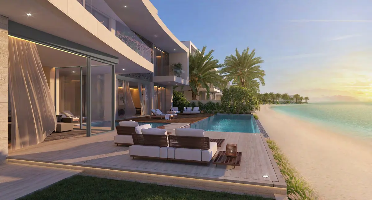 Villa Coral Dune's beach terrace at sunset, with the sea beyond