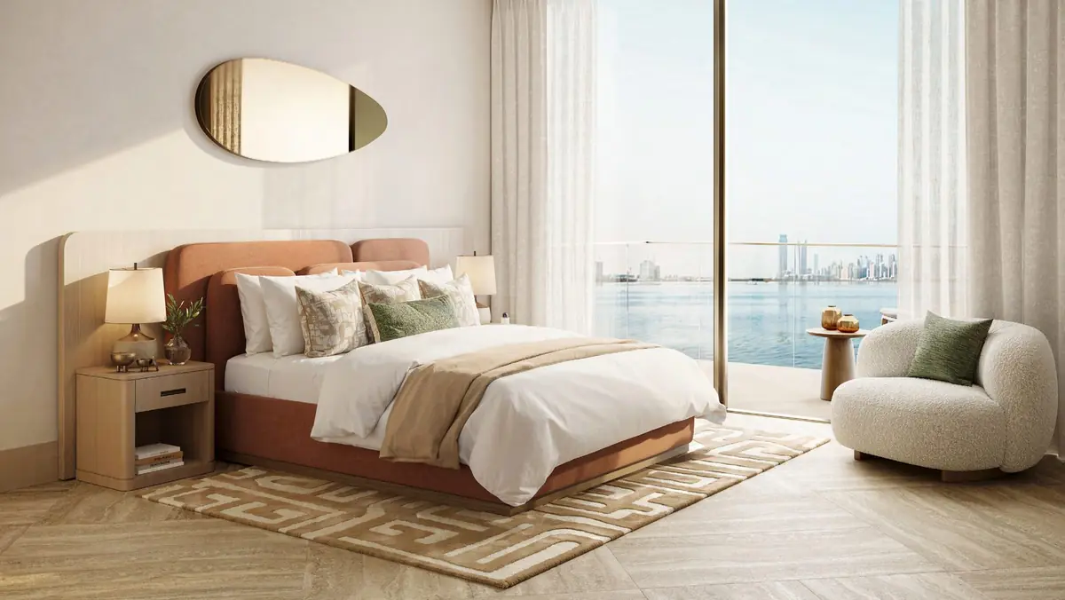 Bedroom beside floor-to-ceiling glazing with a sea view